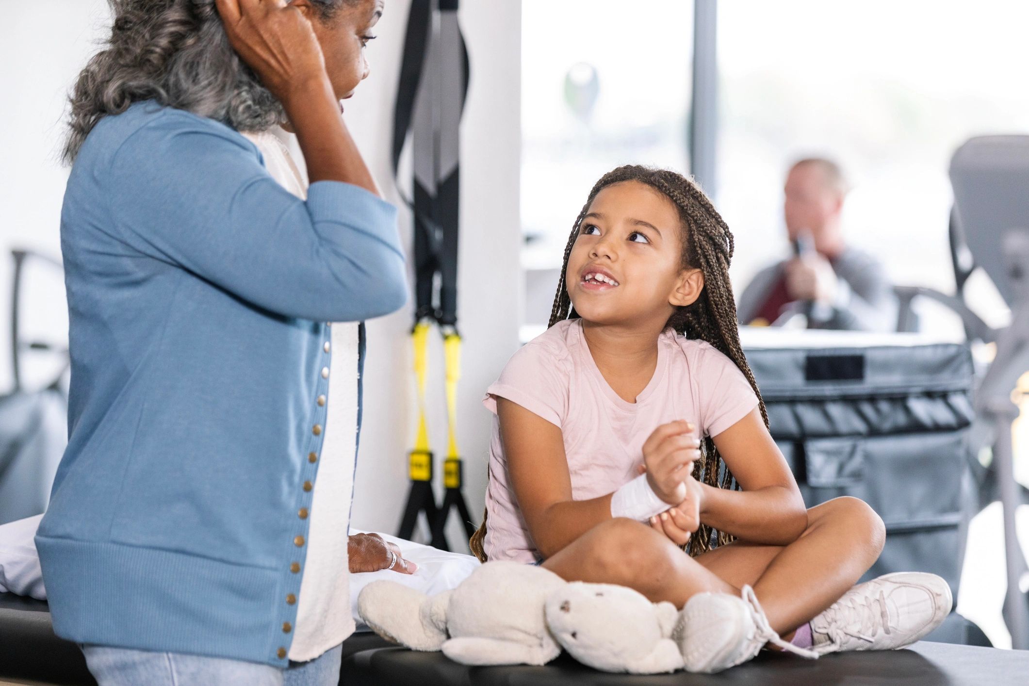 Child sitting on a therapy table at a clinic