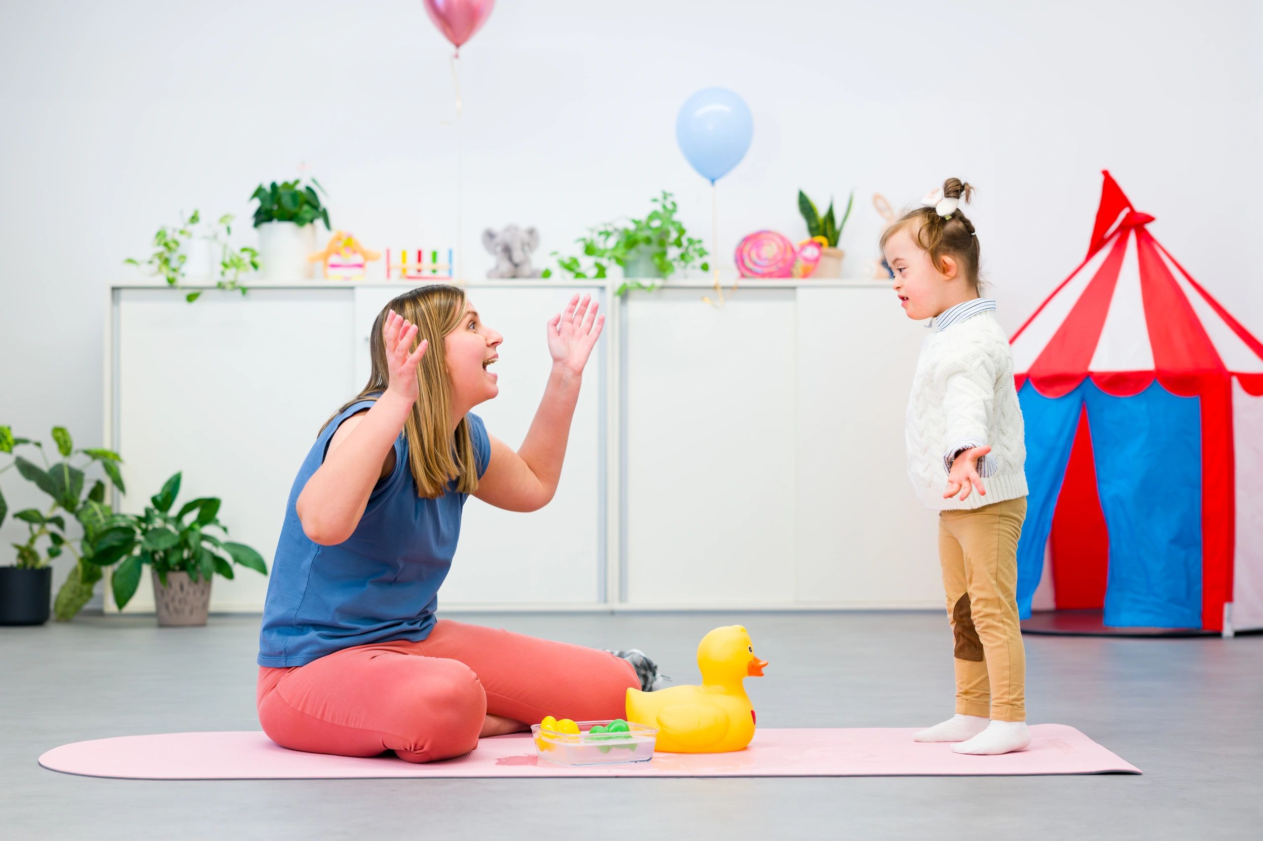 Therapist and child doing playful sensory activities during a therapy session