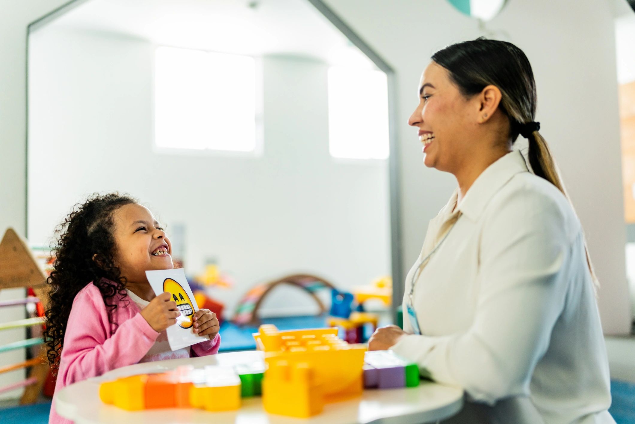 Therapist and child playing a board game during a speech therapy session